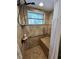 Shower features a tiled bench, window, shower head, and a safety grab bar at 4381 Northshore Dr, Punta Gorda, FL 33980