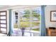 Sunlit window showcasing the lush landscaping, and a glimpse of the street beyond at 4381 Northshore Dr, Punta Gorda, FL 33980