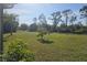 An expansive backyard with mature trees creates a private and picturesque outdoor setting at 501 San Cristobal Ave, Punta Gorda, FL 33983