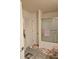 A bathroom has a vanity and a shower-tub combo enclosed with a frosted glass sliding door at 501 San Cristobal Ave, Punta Gorda, FL 33983