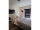 Simple bedroom featuring a bed, mounted TV, a window with blinds, and two chairs at 501 San Cristobal Ave, Punta Gorda, FL 33983