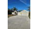 Charming single-story home featuring a wide driveway, two-car garage, and tropical landscaping at 501 San Cristobal Ave, Punta Gorda, FL 33983