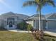 Charming home featuring a well-manicured lawn, a palm tree, and a welcoming entrance at 501 San Cristobal Ave, Punta Gorda, FL 33983