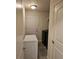 A compact laundry room features a washer, dryer, shelving, and storage space at 501 San Cristobal Ave, Punta Gorda, FL 33983