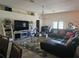 Bright living room features a large sectional sofa, tile floors, and modern decor at 501 San Cristobal Ave, Punta Gorda, FL 33983
