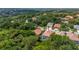 Elevated aerial view featuring a screen enclosed pool, with lush trees surrounding the home at 5017 Hanging Moss Ln, Sarasota, FL 34238