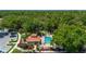 Aerial view of the community pool and clubhouse surrounded by lush green trees and landscaping at 5017 Hanging Moss Ln, Sarasota, FL 34238