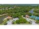 Stunning aerial view showcases the community center, lush landscaping, and serene lake views at 5017 Hanging Moss Ln, Sarasota, FL 34238