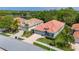 Charming single Gathering home with a terracotta roof, paver driveway and manicured front lawn at 5017 Hanging Moss Ln, Sarasota, FL 34238