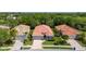 Aerial view of a well-maintained home with lush landscaping and a paver driveway, nestled among mature trees at 5017 Hanging Moss Ln, Sarasota, FL 34238