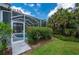 Lush tropical landscaping surrounds the screened-in pool area, offering a private backyard retreat at 5017 Hanging Moss Ln, Sarasota, FL 34238