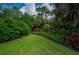 Picturesque backyard with lush greenery, offering privacy and a serene outdoor space at 5017 Hanging Moss Ln, Sarasota, FL 34238