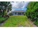 Backyard view of a screened-in pool and lush landscaping, creating a private and peaceful retreat at 5017 Hanging Moss Ln, Sarasota, FL 34238