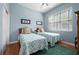 Charming bedroom with two twin beds, a ceiling fan, and natural light creating a peaceful atmosphere at 5017 Hanging Moss Ln, Sarasota, FL 34238