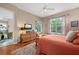 Bedroom featuring hardwood flooring, windows with a view, neutral paint colors and decorative rug at 5017 Hanging Moss Ln, Sarasota, FL 34238