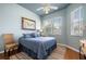 Inviting bedroom with a queen bed, large windows, and a ceiling fan, creating a tranquil retreat at 5017 Hanging Moss Ln, Sarasota, FL 34238