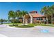 Community clubhouse featuring well-manicured landscaping, ample parking, and an inviting entrance at 5017 Hanging Moss Ln, Sarasota, FL 34238