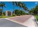 Elegant community entrance with the Turtle Rock sign, palm trees, and brick-paved entry at 5017 Hanging Moss Ln, Sarasota, FL 34238