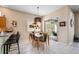 Bright dining area with glass table and bar top, and a view to the patio at 5017 Hanging Moss Ln, Sarasota, FL 34238