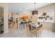 Bright dining area with a modern chandelier and view to the kitchen with bar seating at 5017 Hanging Moss Ln, Sarasota, FL 34238