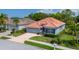 Beautiful view of a single Gathering home featuring a terracotta roof, bay window and paver driveway at 5017 Hanging Moss Ln, Sarasota, FL 34238