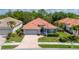 Charming single-story home with a brick driveway, lush landscaping, and a well-maintained lawn at 5017 Hanging Moss Ln, Sarasota, FL 34238