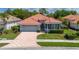 Charming single Gathering home with a terracotta roof and a brick paved driveway at 5017 Hanging Moss Ln, Sarasota, FL 34238