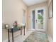 Inviting foyer with a textured rug, decorative table, and a view of the front door at 5017 Hanging Moss Ln, Sarasota, FL 34238