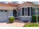 Charming home exterior with well-maintained landscaping and a brick paved walkway to the front door at 5017 Hanging Moss Ln, Sarasota, FL 34238