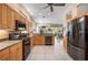 Bright kitchen featuring stainless steel appliances, tile flooring, wood cabinets, and granite countertops at 5017 Hanging Moss Ln, Sarasota, FL 34238