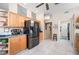 Bright kitchen featuring stainless steel refrigerator, wood cabinets and eat in nook with seating at 5017 Hanging Moss Ln, Sarasota, FL 34238