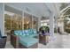 Relaxing lanai with sectional seating, fire table, and views of the pool and landscaped backyard at 5017 Hanging Moss Ln, Sarasota, FL 34238