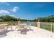 Scenic outdoor seating area overlooking a serene lake with a fountain and lush landscaping at 5017 Hanging Moss Ln, Sarasota, FL 34238