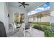 Enjoy outdoor living on this screened patio with a cozy dining set and serene backyard views at 5017 Hanging Moss Ln, Sarasota, FL 34238