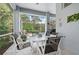 Relaxing screened patio features a dining set with views of the lush, tropical landscaping at 5017 Hanging Moss Ln, Sarasota, FL 34238
