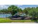 View of community playground featuring slides and picnic tables with the community pool in the distance at 5017 Hanging Moss Ln, Sarasota, FL 34238