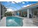 Inviting screened-in pool with outdoor seating, perfect for relaxing and entertaining in a private backyard oasis at 5017 Hanging Moss Ln, Sarasota, FL 34238