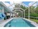 The backyard features an inviting pool area with comfortable seating and lush landscaping views at 5017 Hanging Moss Ln, Sarasota, FL 34238