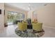 Inviting sitting area with bright seating, and view to the outdoor pool and patio at 5017 Hanging Moss Ln, Sarasota, FL 34238
