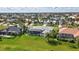Expansive aerial shot showcasing a home with a screened-in pool and manicured lawn in a residential area at 507 Monaco Dr, Punta Gorda, FL 33950