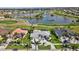 Scenic aerial view showcasing three homes with manicured lawns, a golf course, and a large lake at 507 Monaco Dr, Punta Gorda, FL 33950