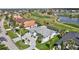 Aerial view of a lovely single-story house with a screened-in pool area and nearby golf course and pond at 507 Monaco Dr, Punta Gorda, FL 33950