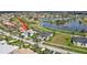 Aerial view of a lovely single-story house with a screened-in pool area and nearby golf course and pond at 507 Monaco Dr, Punta Gorda, FL 33950