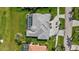 Overhead view of a well-maintained home featuring a screened-in pool, manicured lawn, and landscaped garden at 507 Monaco Dr, Punta Gorda, FL 33950