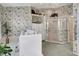 Bathroom with floral wallpaper, large walk-in tub, and glass-enclosed shower at 507 Monaco Dr, Punta Gorda, FL 33950