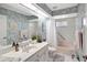 Stylish bathroom with pink fixtures, including a bathtub and toilet, complemented by a white vanity at 507 Monaco Dr, Punta Gorda, FL 33950