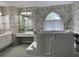 Bathroom featuring a walk-in tub and separate vanity area, bathed in soft, natural light at 507 Monaco Dr, Punta Gorda, FL 33950
