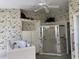 Bathroom featuring a walk-in shower and a jetted tub, complemented by floral wallpaper at 507 Monaco Dr, Punta Gorda, FL 33950