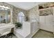 Bright bathroom with floral wallpaper, large walk-in tub, and vanity at 507 Monaco Dr, Punta Gorda, FL 33950