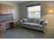 Functional bedroom with a comfortable sofa, built-in desk, and ample cabinet storage at 507 Monaco Dr, Punta Gorda, FL 33950